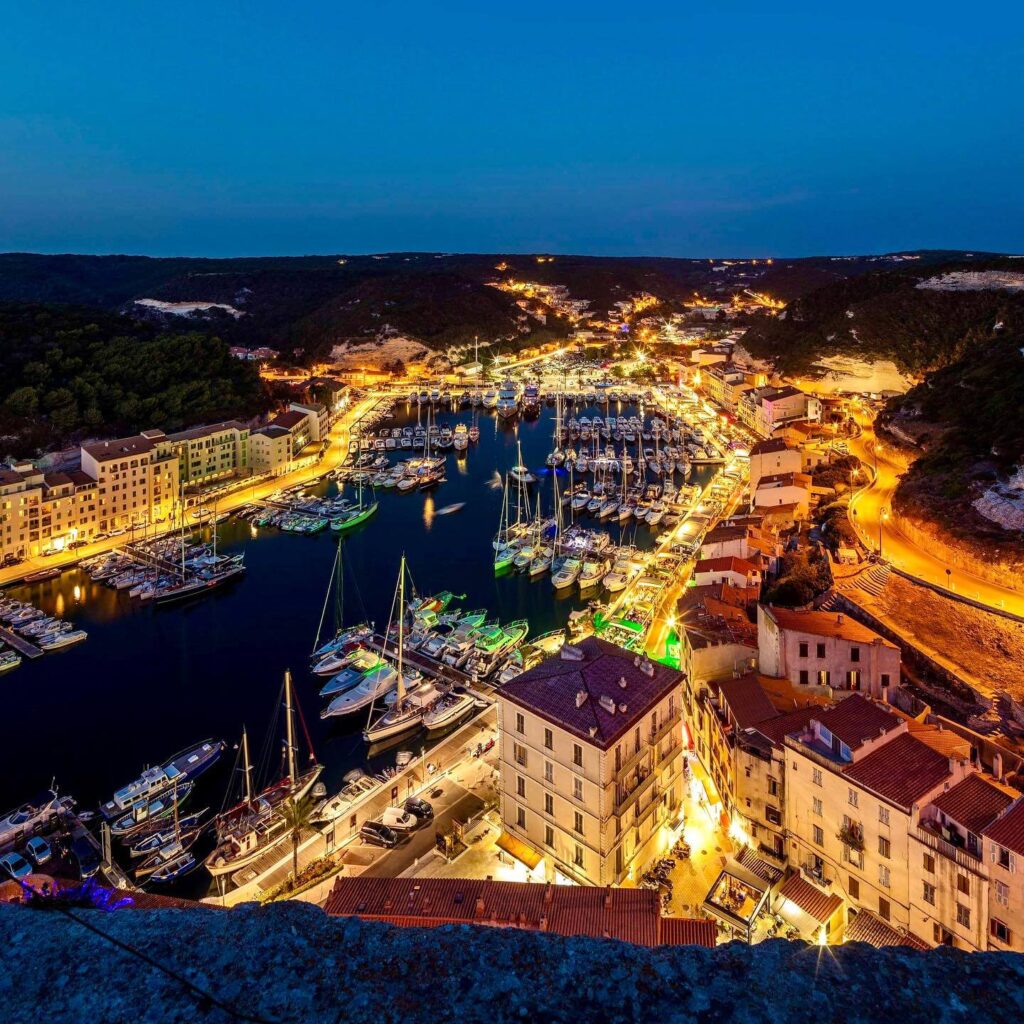 Bonifacio marina in the evening with restaurants and boats along the harbor