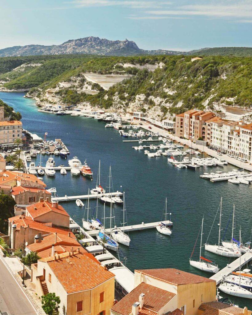Bonifacio marina with boats and waterfront restaurants in the evening