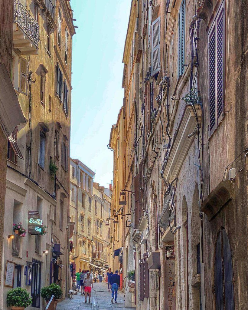 Narrow streets in Bonifacio old town with stone buildings and small cafes
