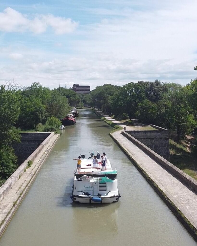 Tree-lined Canal du Midi near Carcassonne with walking path