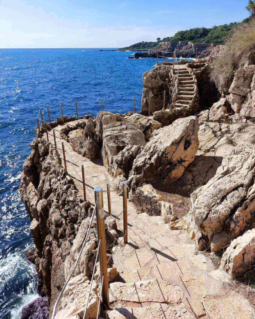 Scenic coastal path at Cap d Antibes with cliffs and sea