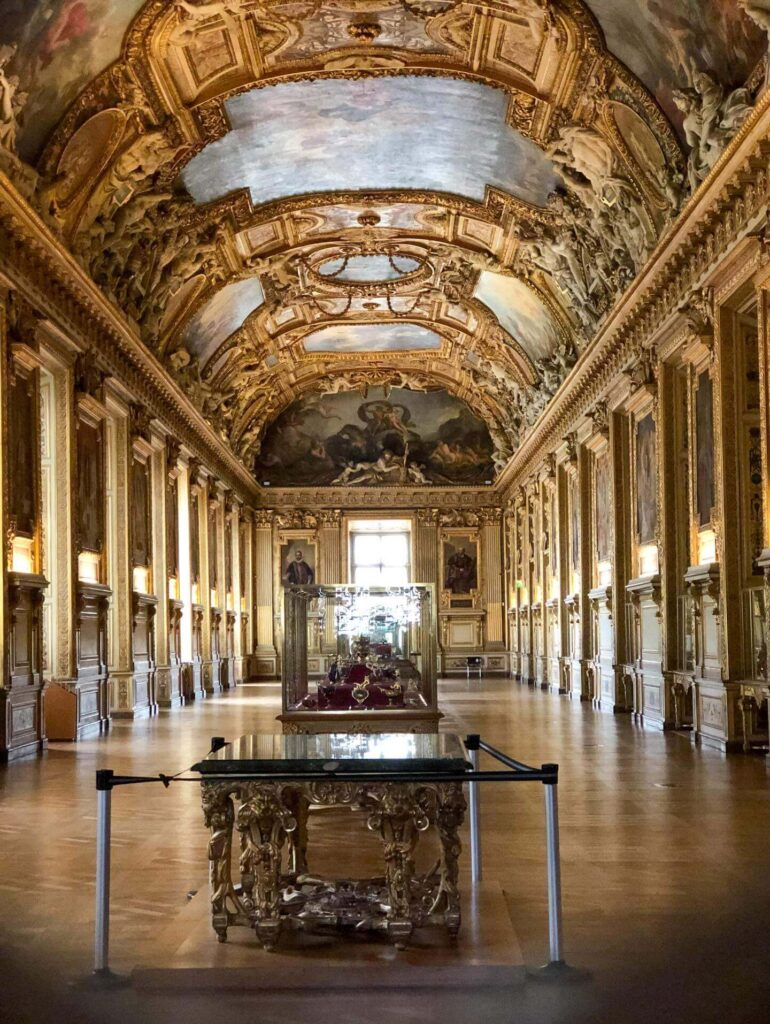 Crowded gallery inside the Denon Wing of the Louvre Museum