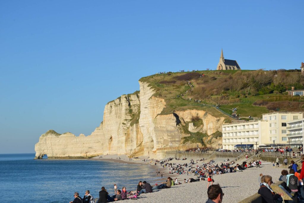Pebble beach in Étretat with cliffs rising above
