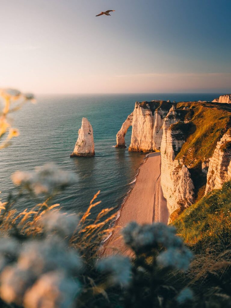 Sunset over Étretat cliffs and natural arch