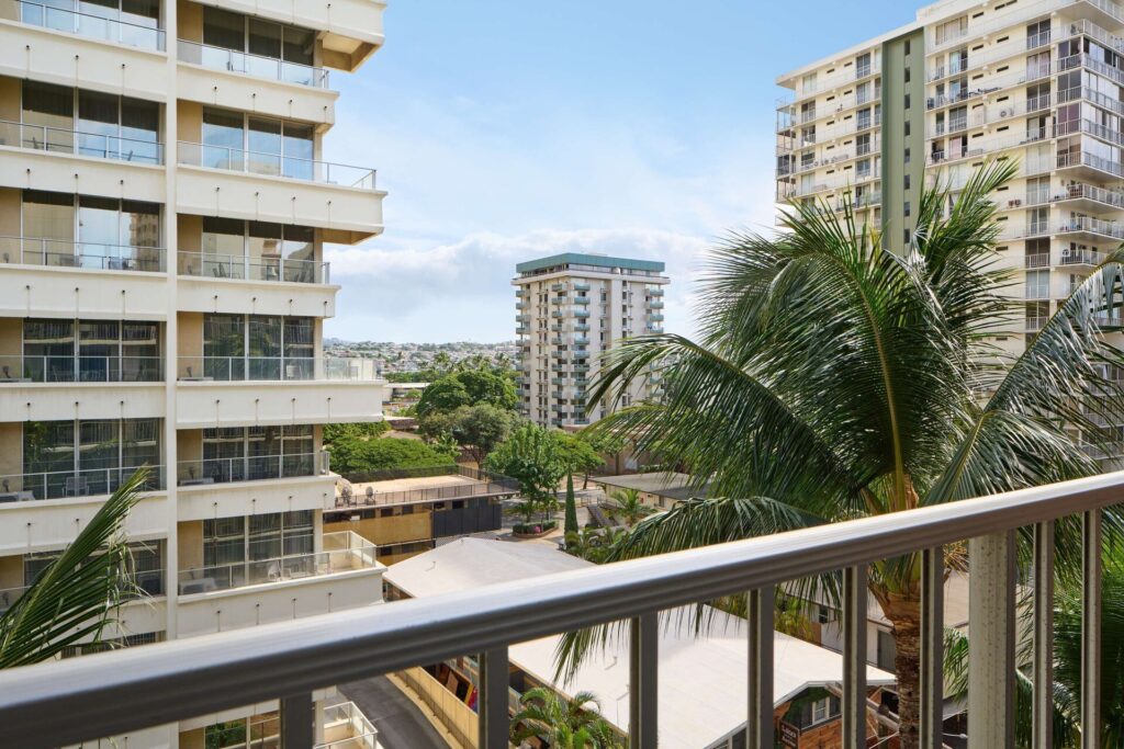 Exterior view of Ewa Hotel Waikiki in Waikiki, featuring budget-friendly accommodations, a simple high-rise design, rooftop sundeck, and convenient location near the beach.
