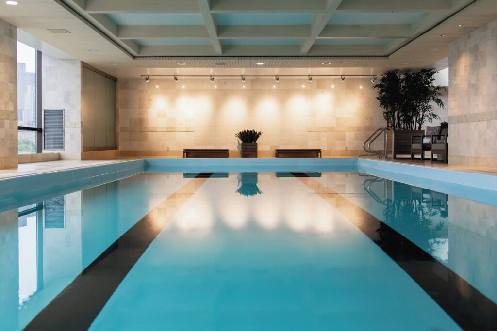 Indoor pool at Four Seasons Hotel Boston with large windows and skyline views