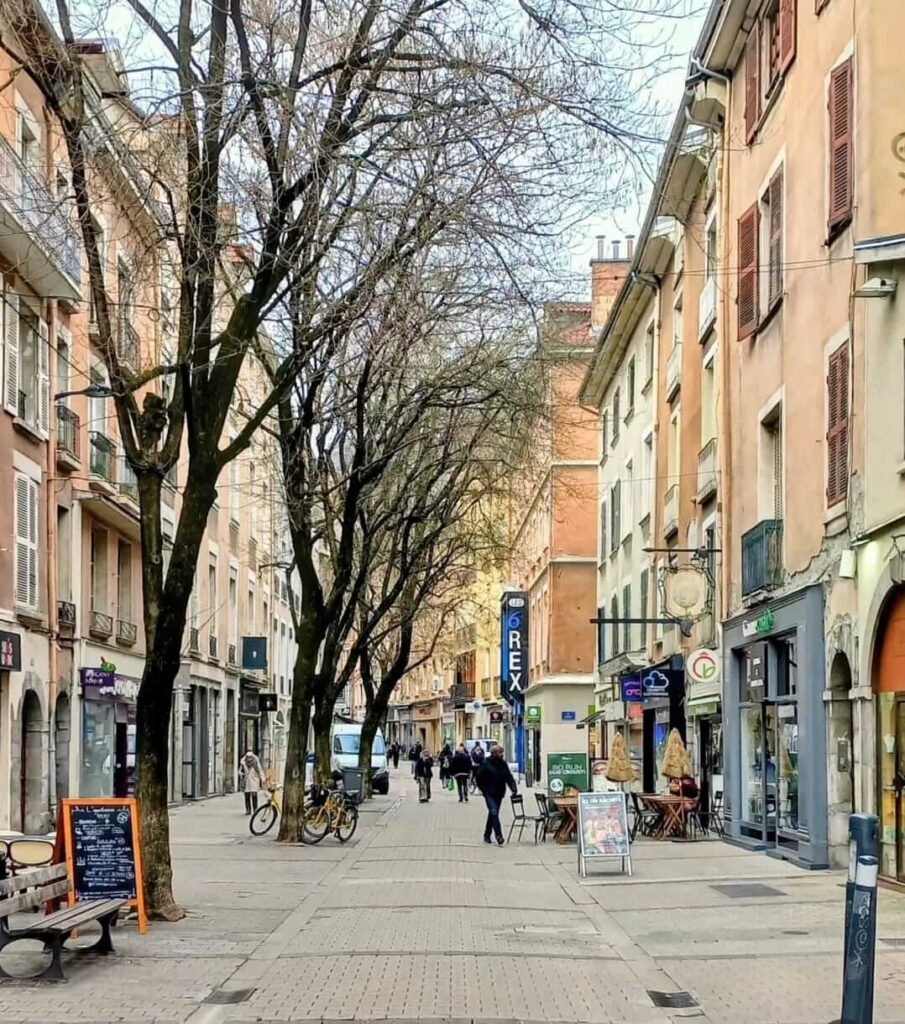 Street view of Grenoble Old Town with cafes and buildings
