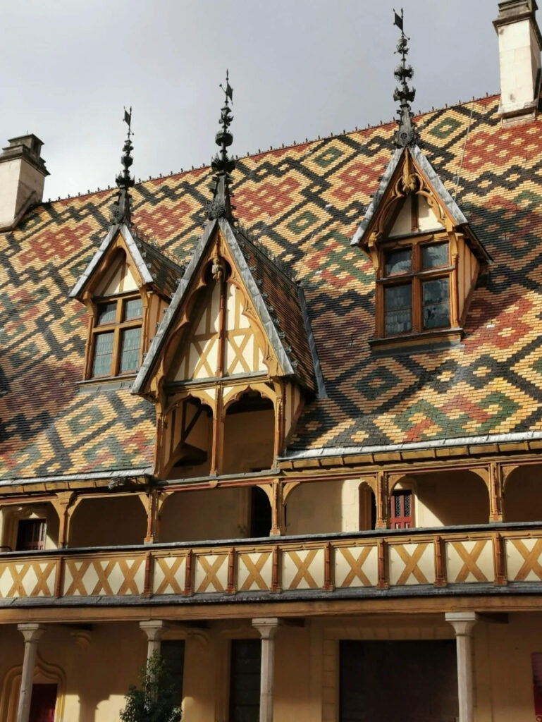 Exterior of Hôtel Dieu in Beaune with colorful tiled roof