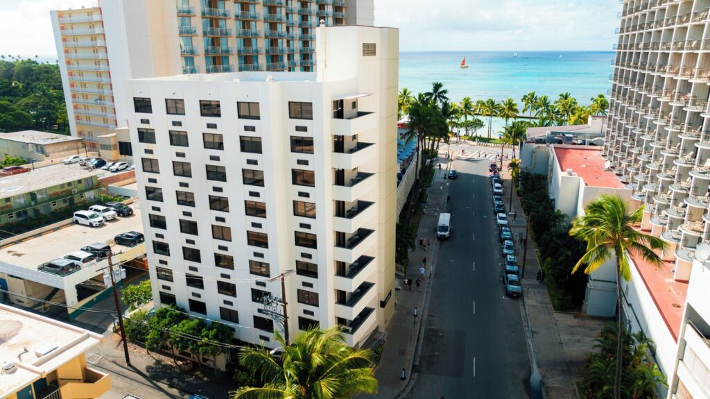 Exterior view of Hotel Renew in Waikiki, featuring a modern boutique design, minimalist interiors, and a relaxed stay just steps from the beach.