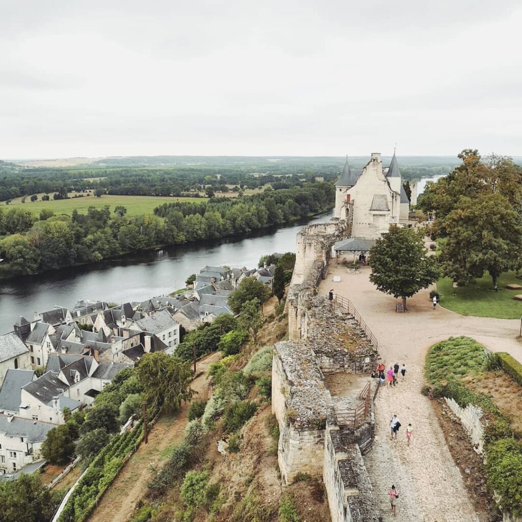 Scenic view of Chinon with fortress, river, and old town in a calm setting
