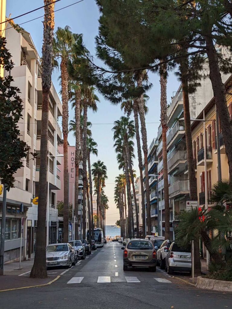 People relaxing on sandy beach in Juan les Pins