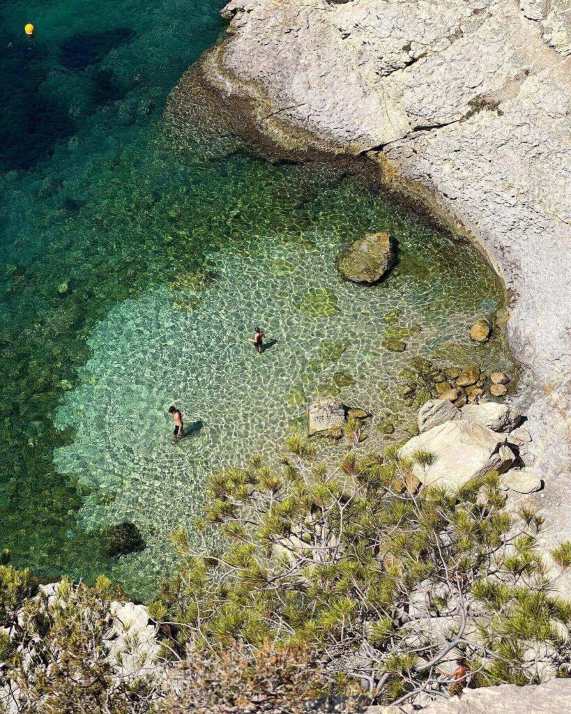 Rocky shoreline at a calanque in La Ciotat showing uneven terrain