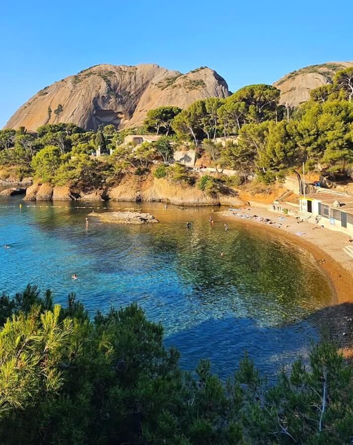 Busy beach in La Ciotat during summer with people swimming and relaxing