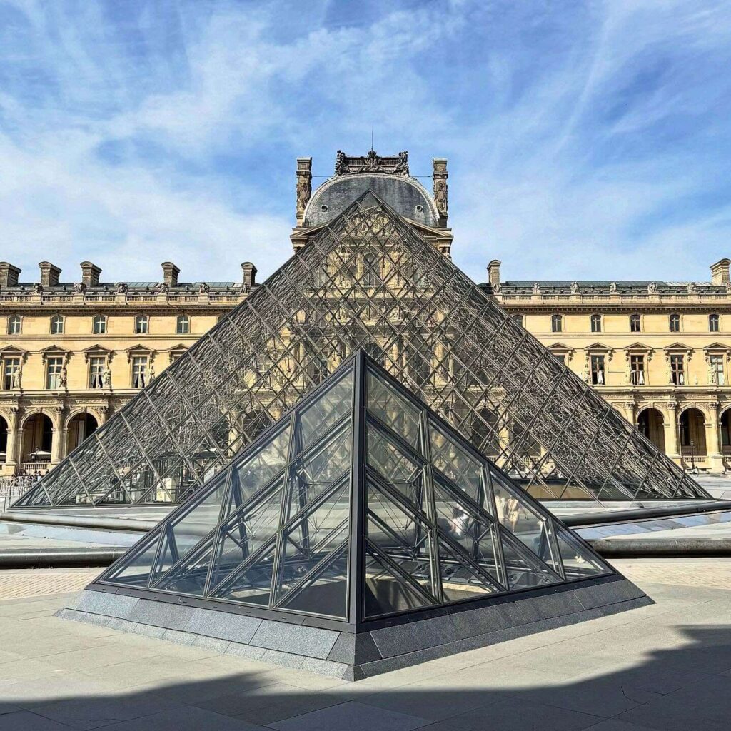 Historic Louvre Museum palace exterior in Paris showing its architectural scale