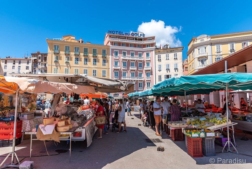 Local market in Ajaccio with cheese, charcuterie, and fresh produce