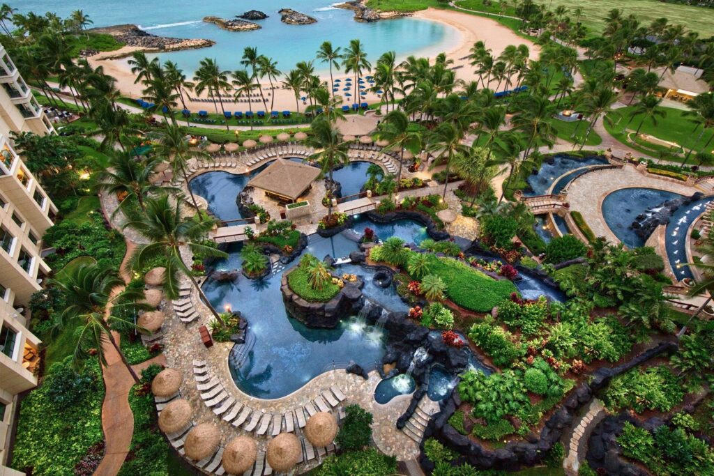 Exterior view of Marriott's Ko Olina Beach Club in Oahu, featuring beachfront villas, lagoon views, palm trees, and family-friendly luxury resort surroundings.