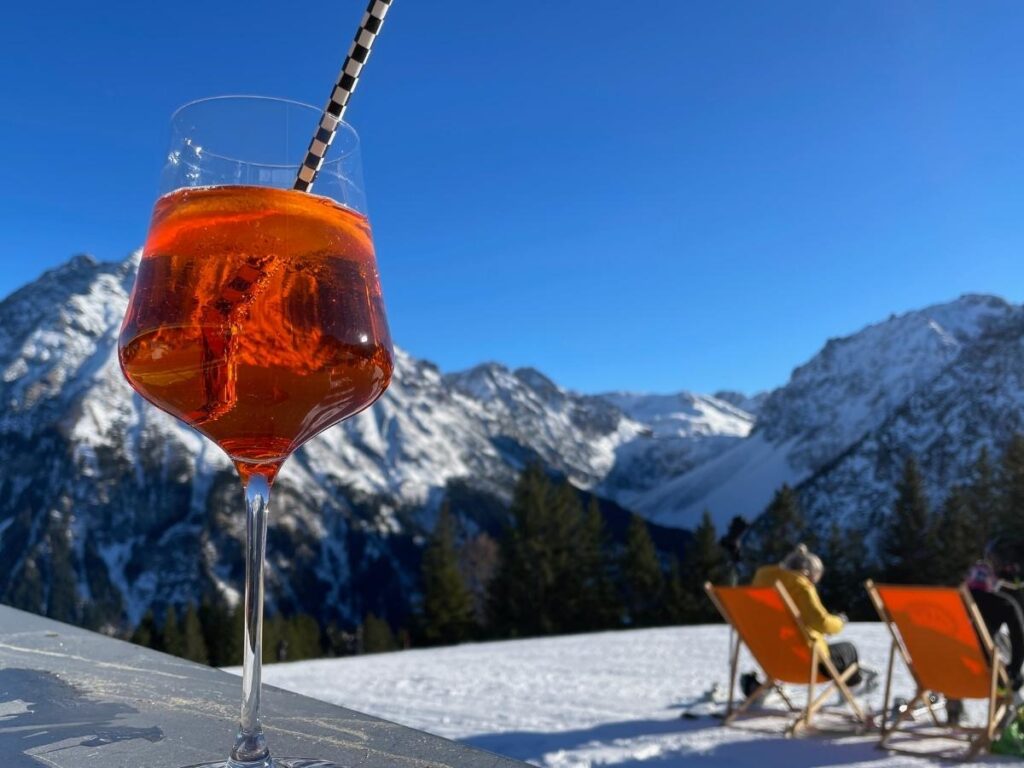 Relaxed après ski terrace in Megève with mountain views at sunset