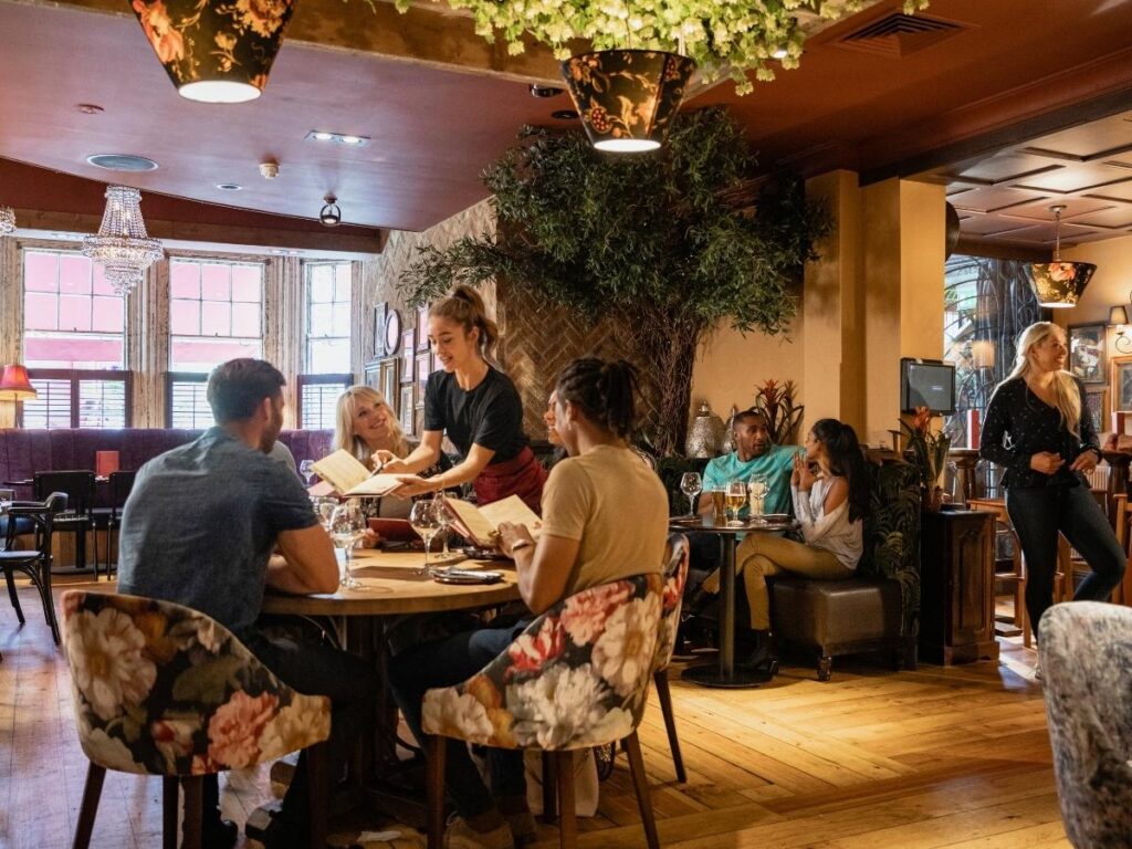 People sharing fondue dinner together in a Megève alpine restaurant