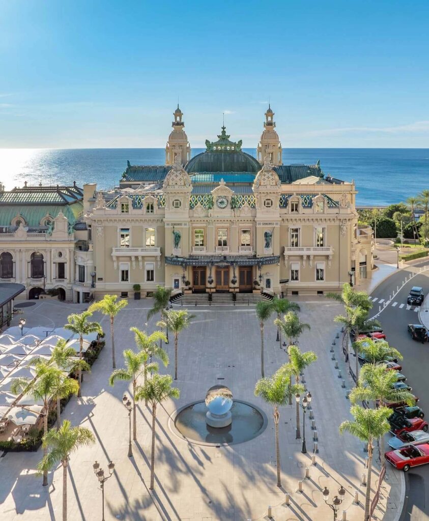 Monte Carlo Casino square with historic buildings and luxury cars