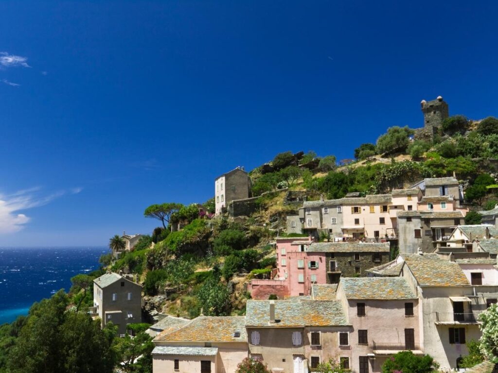 Nonza village perched on a cliff with sweeping views of the sea