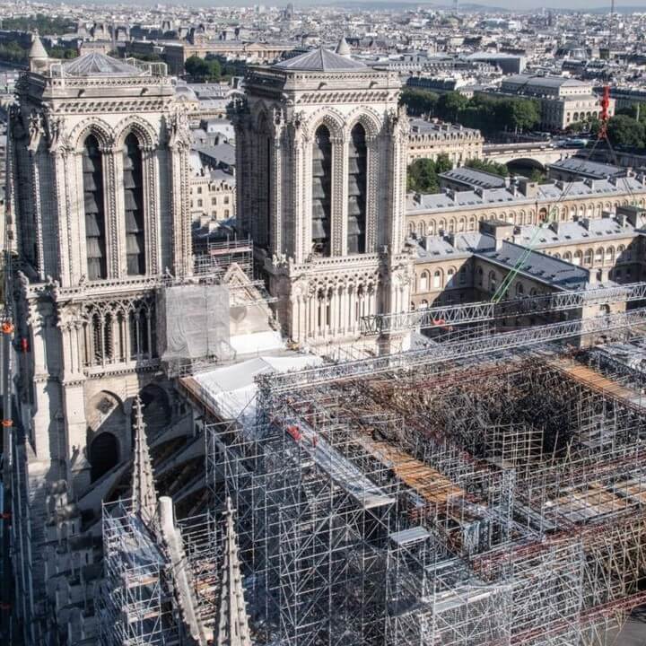 Restoration work at Notre Dame cathedral showing scaffolding and rebuilding efforts