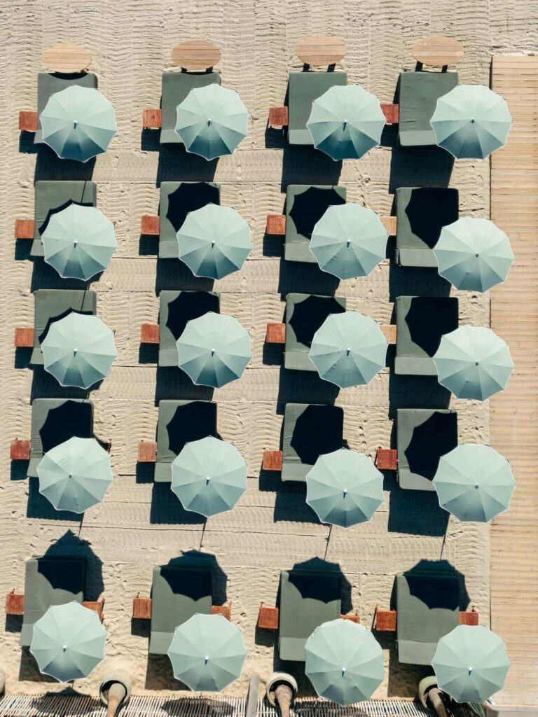 Sunbeds and umbrellas arranged at Pampelonne Beach in Saint Tropez