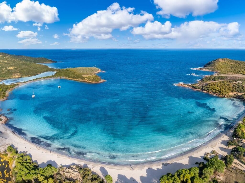Curved bay of Rondinara Beach with calm clear water
