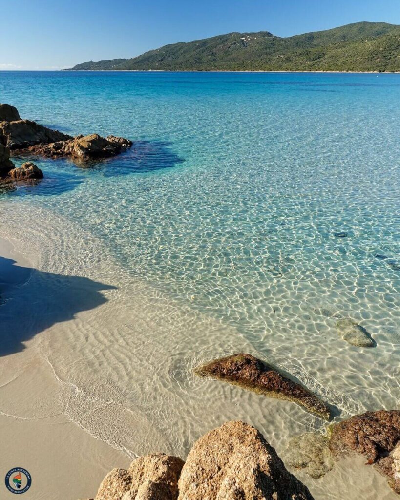 Calm beach in Porto Vecchio with clear shallow water and soft sand