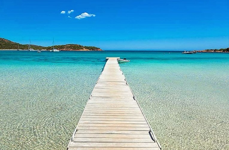 Coastal view of Porto Vecchio with clear blue water and surrounding landscape