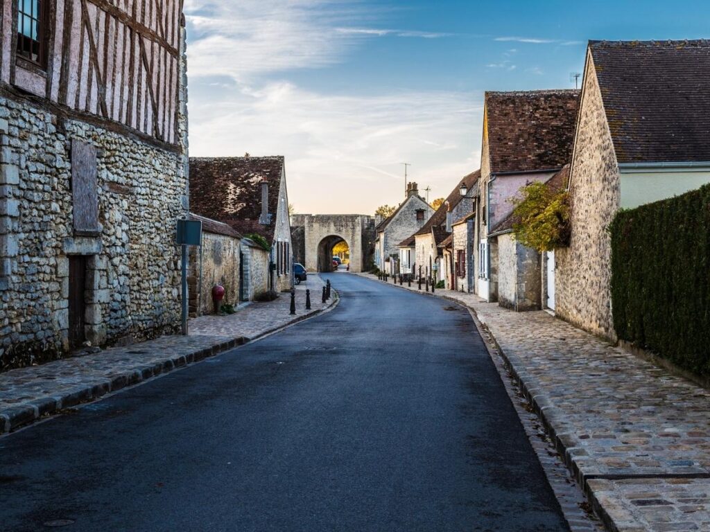 View of Provins upper town with medieval buildings and towers on a hill