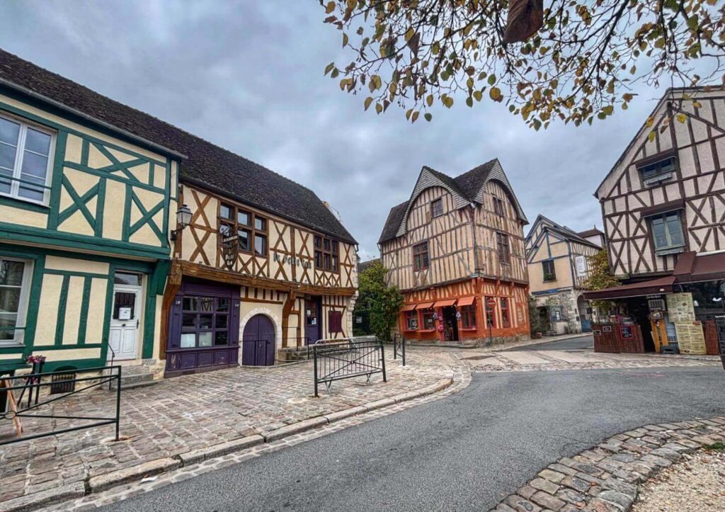 Quiet street in Provins upper town with stone buildings and wooden shutters