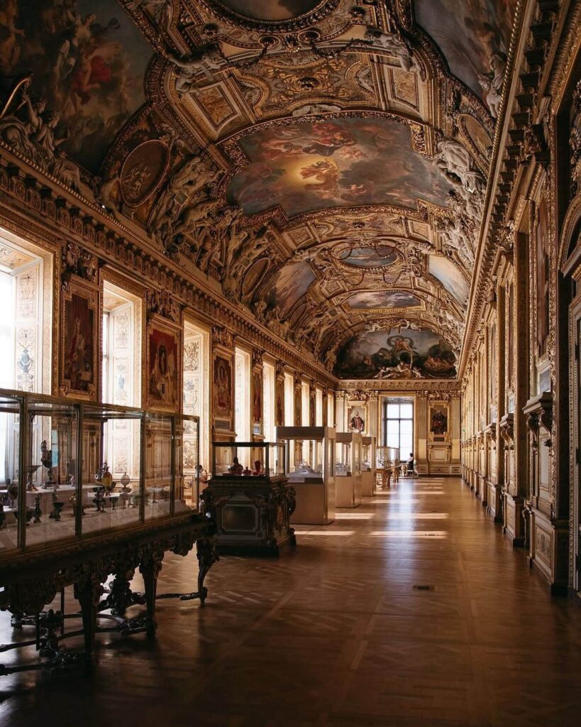 Quiet gallery inside the Louvre Museum with fewer visitors