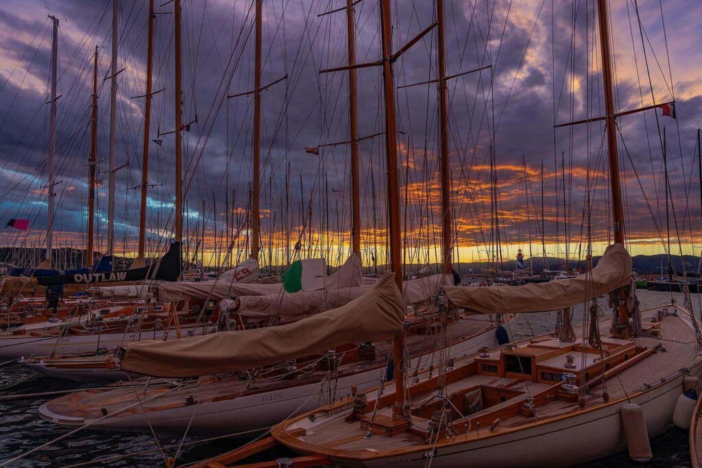 Evening view of Saint Tropez harbor with warm light and waterfront cafes