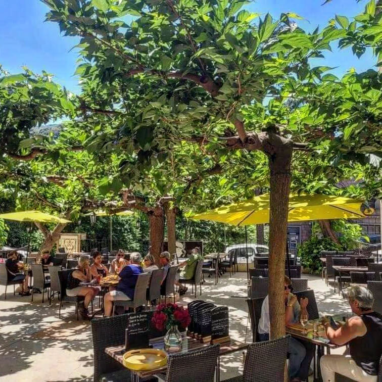 People sitting at a café in Sartène main square with relaxed atmosphere