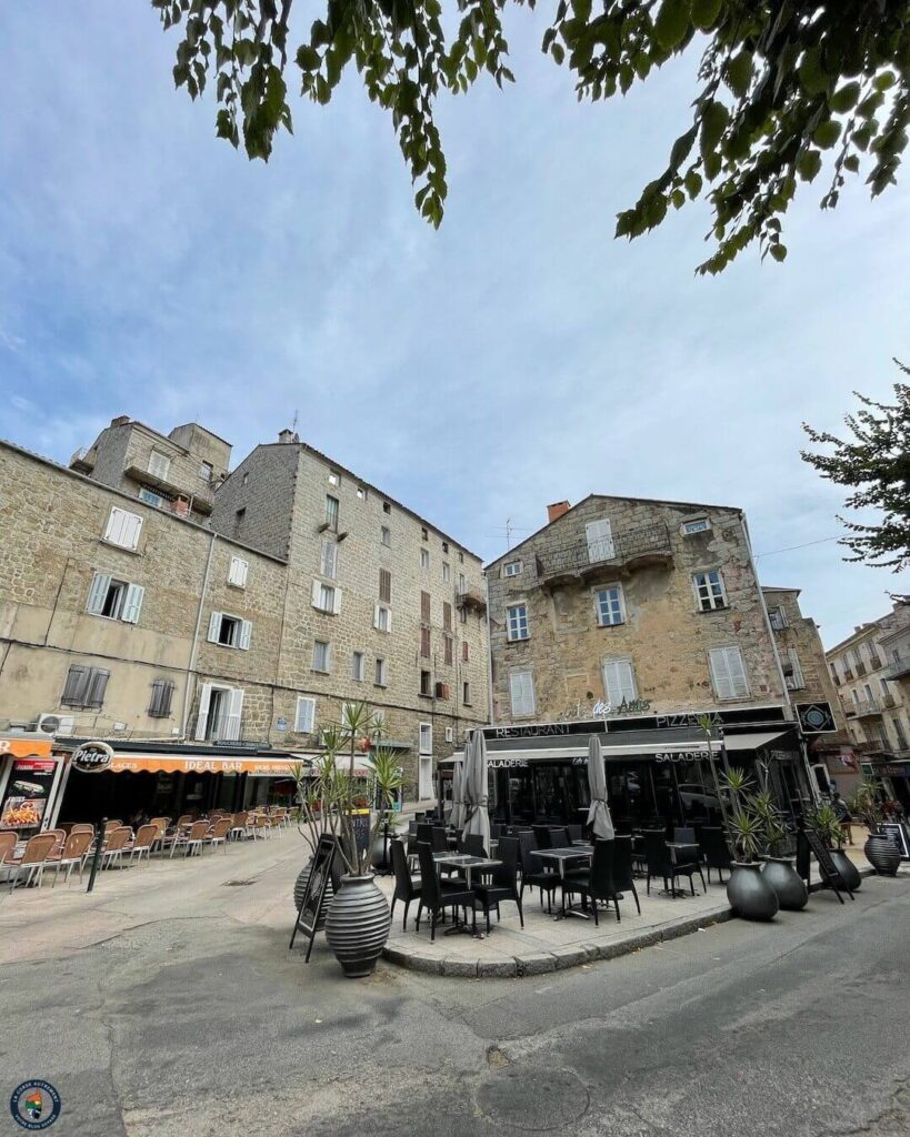 Walking through narrow stone streets in Sartène old town Corsica