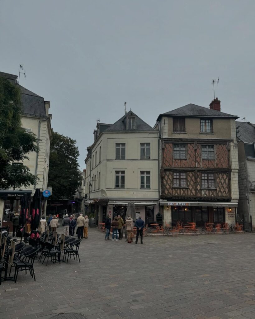 Quiet street in Saumur old town with cafés and historic buildings