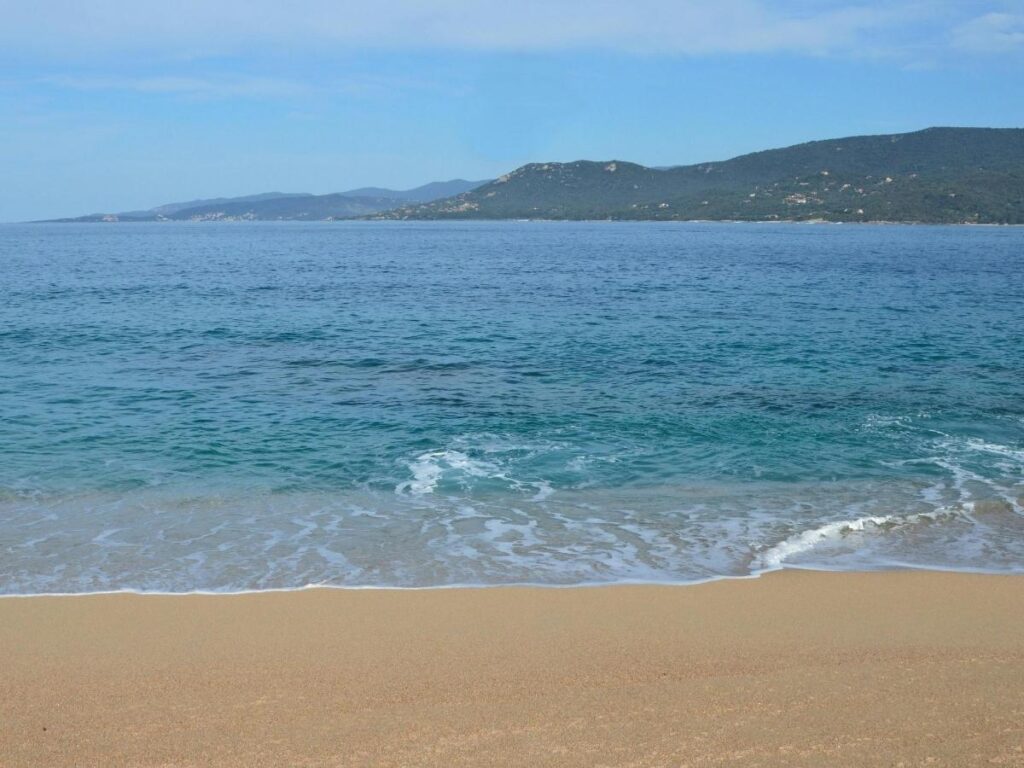 Tizzano beach near Sartène with calm water and coastal village