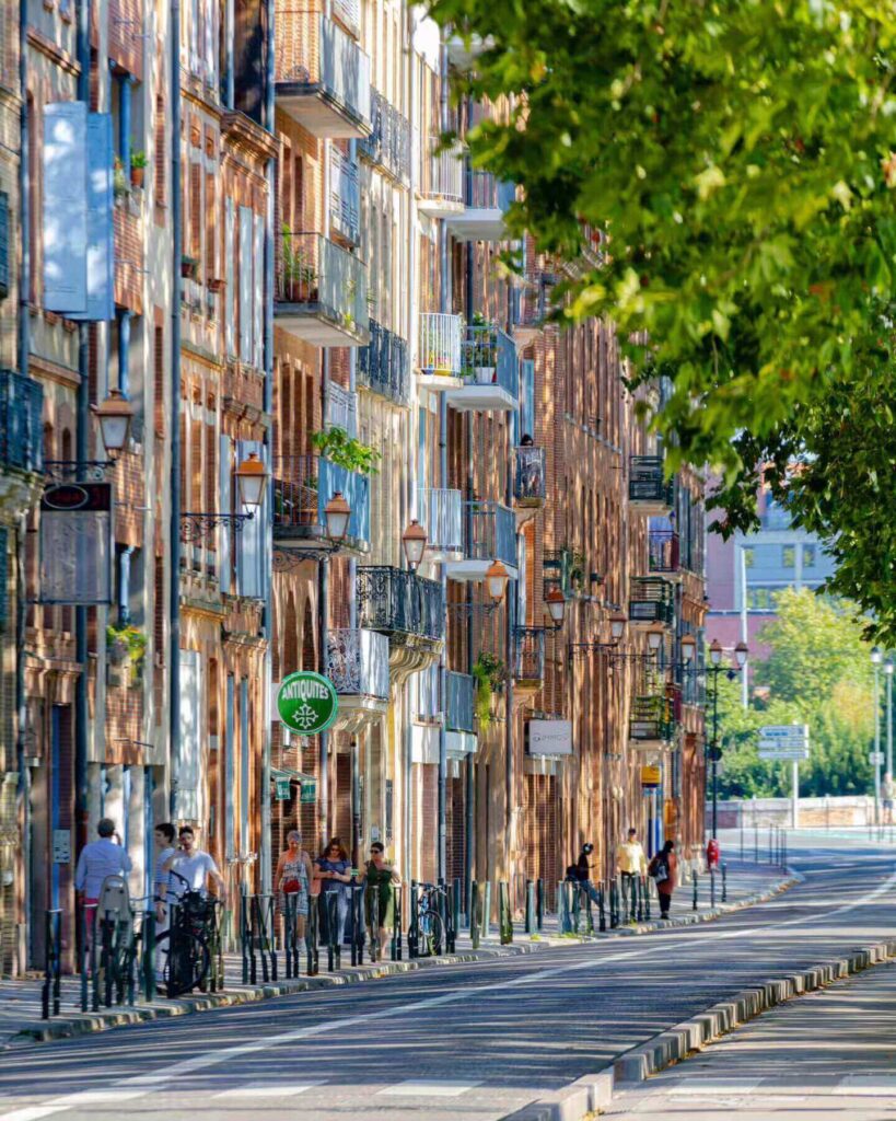 Narrow street in Toulon Old Town with colorful buildings and local cafés