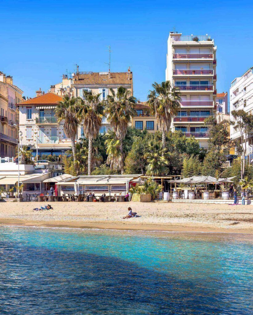 Seafront promenade in Toulon with people walking along the coast