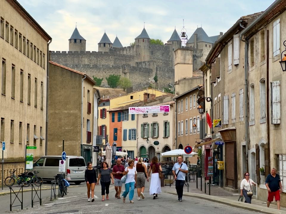 Walking through narrow streets inside Carcassonne medieval city