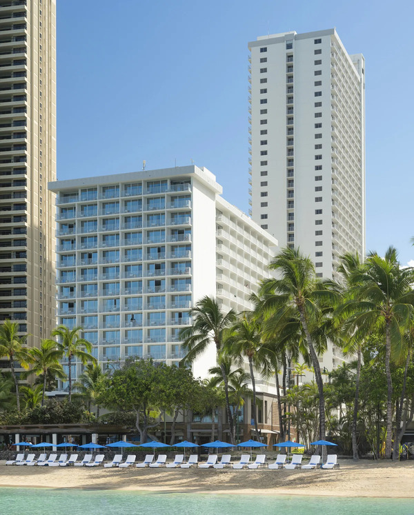 Exterior view of Alohilani Resort Waikiki Beach featuring modern oceanfront architecture near Waikiki Beach in Hawaii.