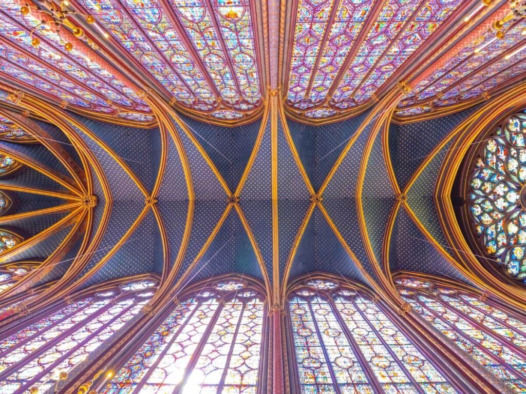 Central view inside Sainte-Chapelle upper chapel surrounded by stained glass