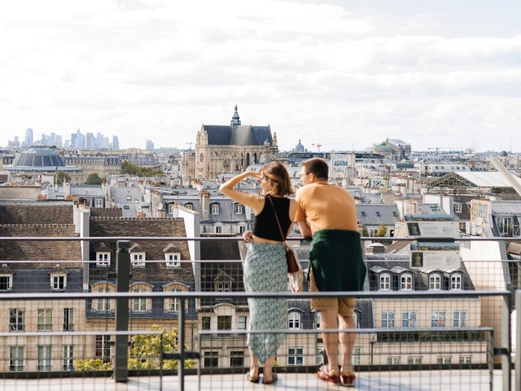 Visitor taking a break on the rooftop of Centre Pompidou overlooking Paris