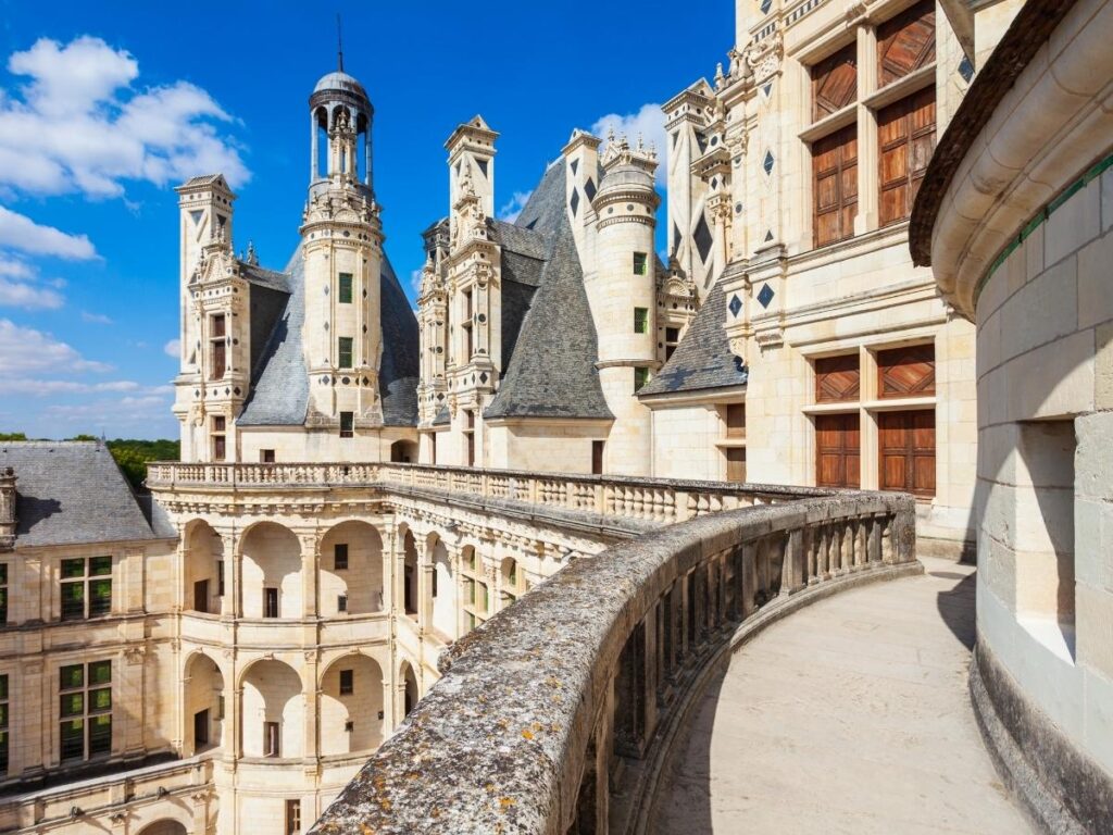 Visitor exploring rooftop terraces at Château de Chambord