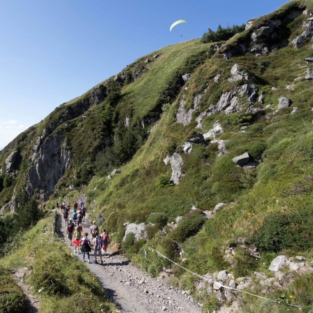 Hikers climbing the Chemin des Muletiers trail at Puy de Dôme