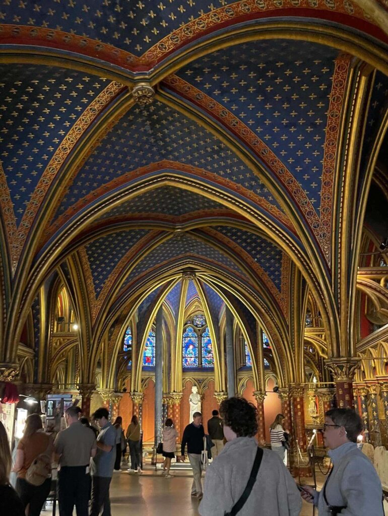 Couple admiring stained glass inside Sainte-Chapelle