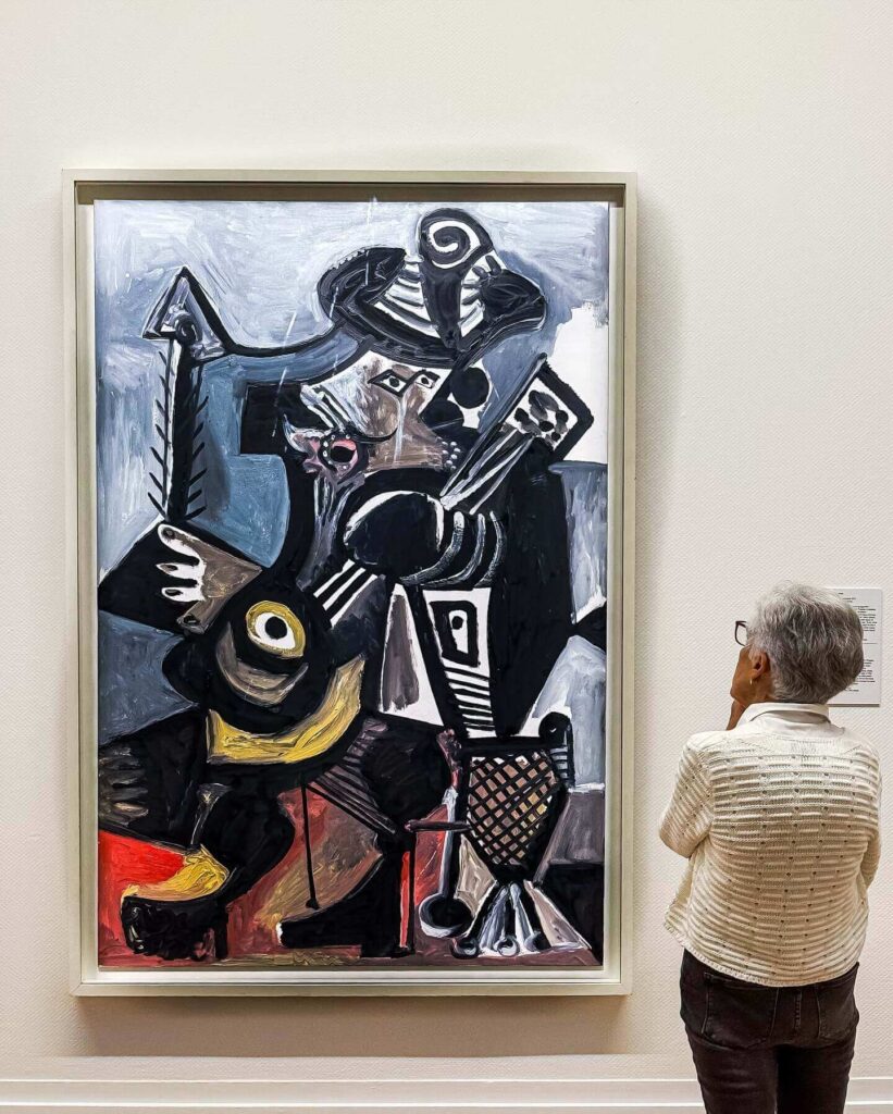 Visitors exploring Cubist artwork at Musée Picasso Paris