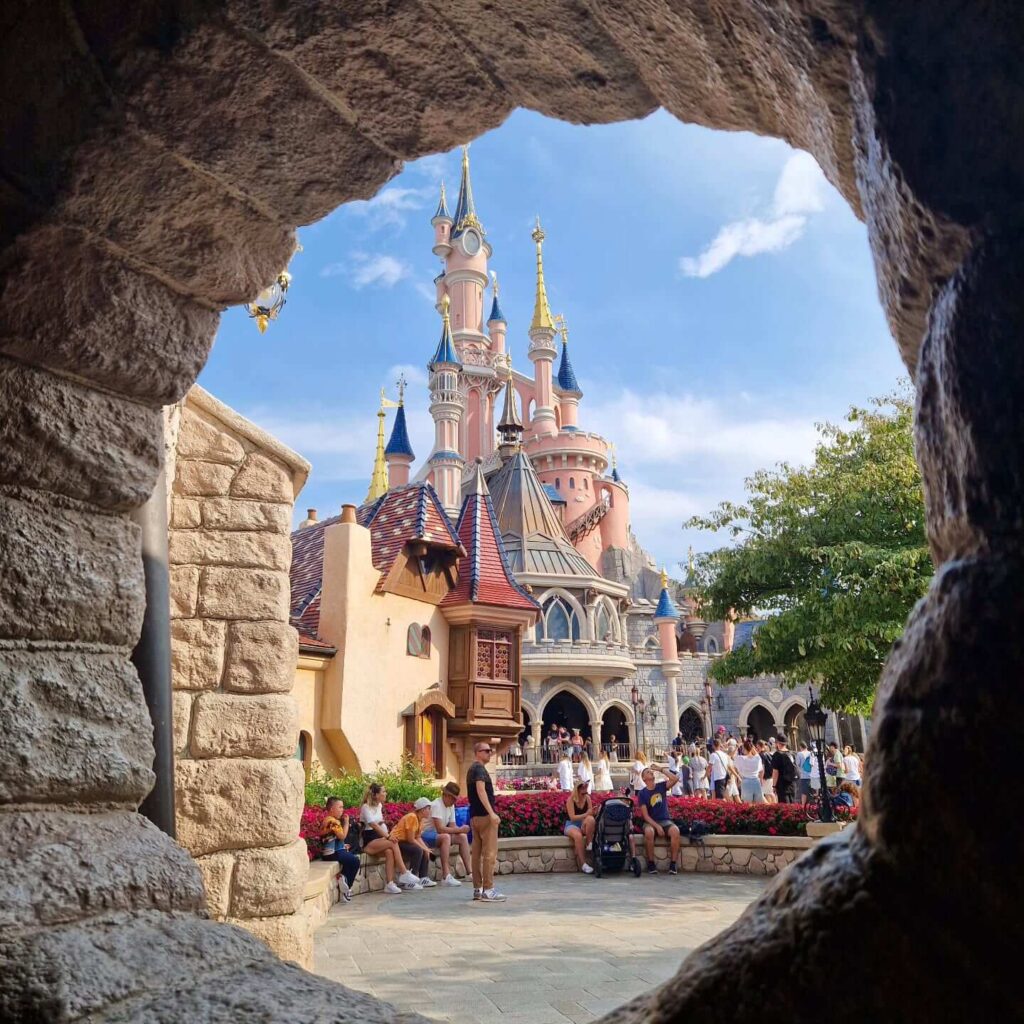 Sleeping Beauty Castle illuminated at night in Disneyland Paris