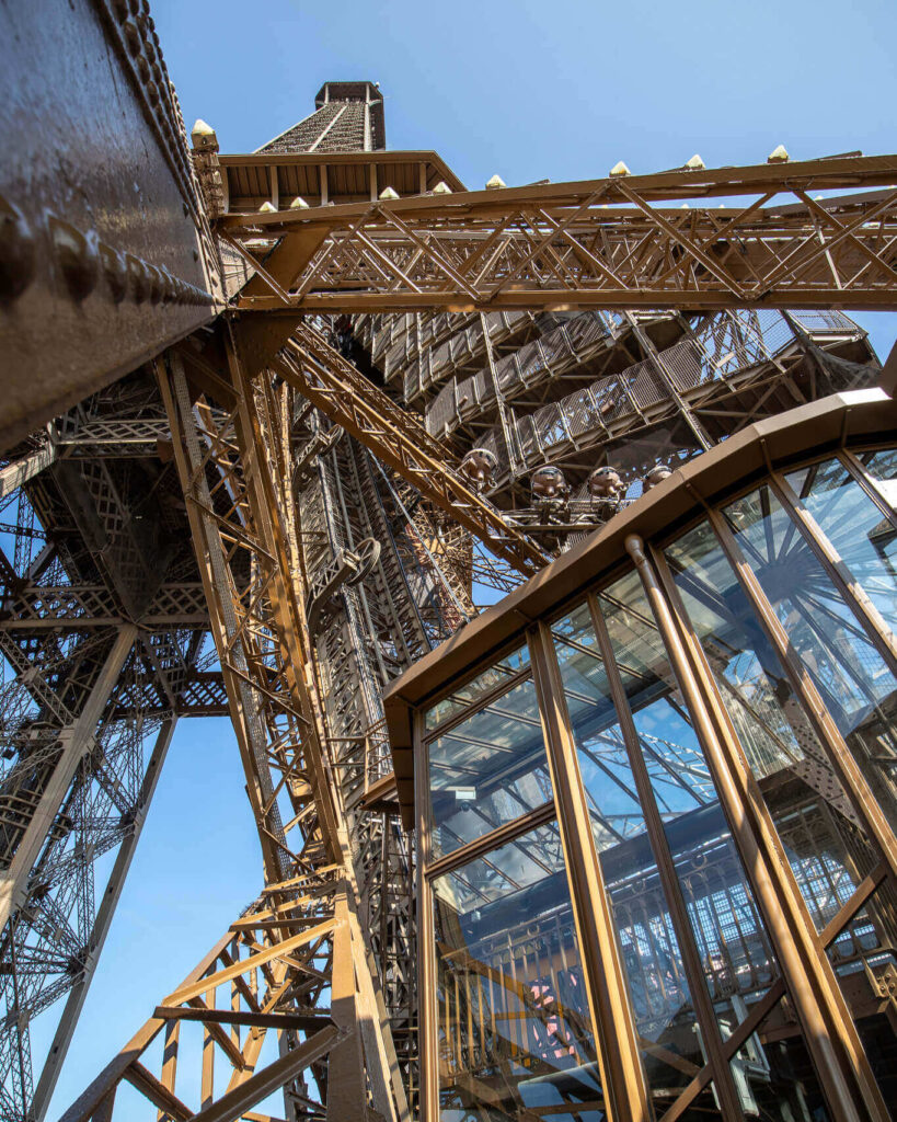 Crowded interior of the Eiffel Tower elevator with visitors standing close together