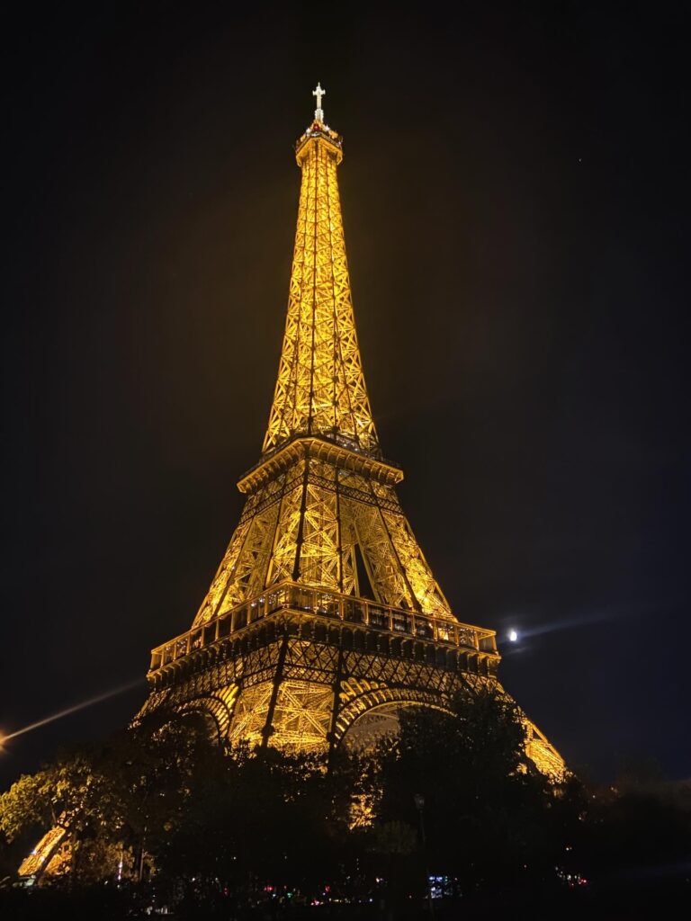 Quiet evening walk near the Eiffel Tower with soft lights in Paris